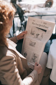 Woman Holding the New York Times Newspaper